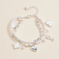 Layered Pearl Charm Bracelet – Love, Heart, and Clover Pendants